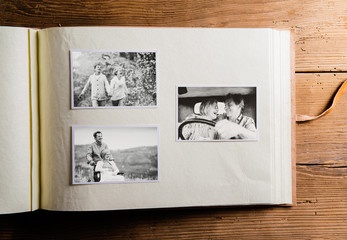 Photo album with black-and-white pictures of senior couple.