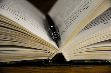 Open book and fountain pen