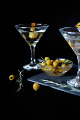 Margarita cocktail alcohol drink in glass with green olives