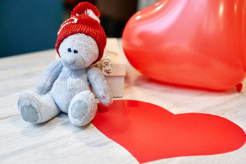 teddy bear and gift box on a wooden table in Valentine's Day