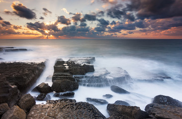Sunbeams on a beautiful sunset at a isolated beach