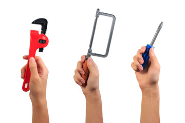 Engineer tool toy concept. Boy hand holding wrench, fret saw and screwdriver toy tool isolated on...