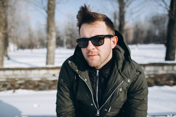 Portrait of a handsome stylish young man in winter.