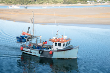 Fishing boat arrives in the port of Padstow at the Camel estuary in north Cornwall.