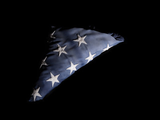 Closeup of a old american flag on a black background
