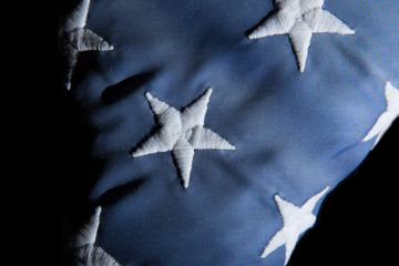 Closeup of a old american flag on a black background