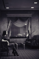 Naklejka na ściany i meble lonely sad woman in the hotel interior