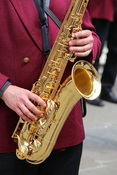 player plays the saxophone in the brass band