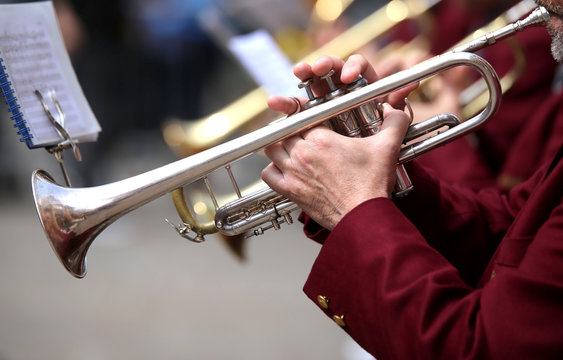 trumpeter plays his trumpet in the brass band during live concer