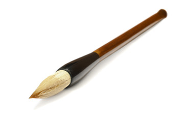 Traditional Chinese calligraphy brush lying on a white background