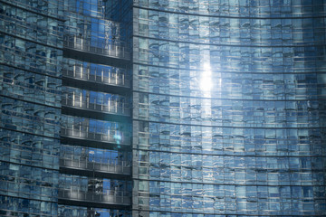 Sun reflected on the glass facade of a modern office building