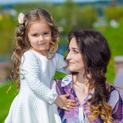Obraz premium little girl hugging her mother emotionally
