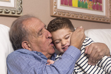 Grandfather kissing his grandson