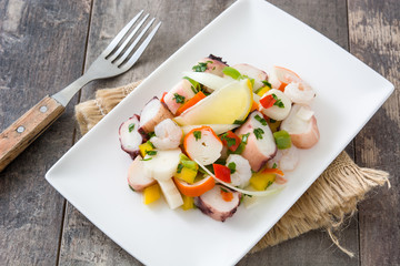 Traditional seafood ceviche from Peru on wooden background
