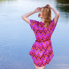beautiful girl in a pink dress on the beach