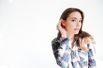 Fototapeta premium Pretty woman standing with hand at ear to hear better