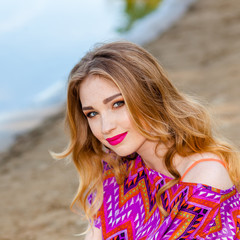 beautiful girl in a pink dress on the beach