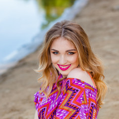 beautiful girl in a pink dress on the beach