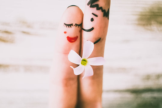 Painted finger smiley on red background, valentine concept.