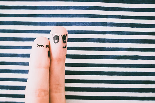 Painted finger smiley on red background, valentine concept.