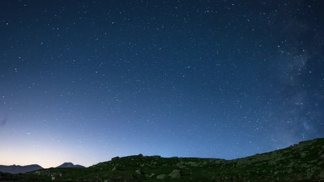nighttime star time lapse of the Great St Bernard Pass mountains in the Swiss Alps.