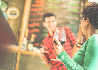 Happy friends toasting red wine at winery pub restaurant