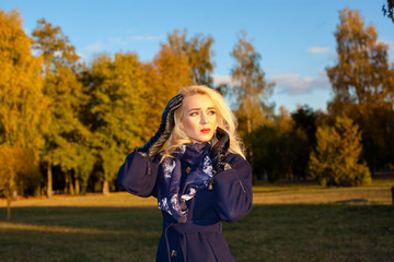 sad woman with a headache outdoors in autumn