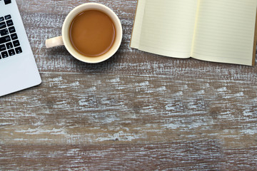 Top view book and computer and coffee on wooden background