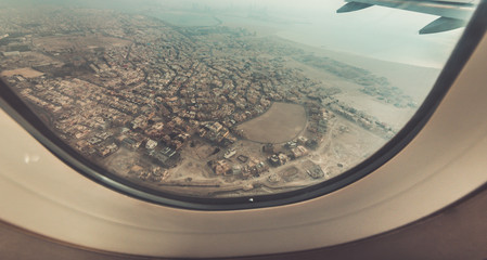 Airplane window view with a landscape scenery background in vintage style.