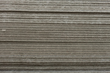 A side view on the Flat slate sheets stacked on each other. Material for construction. Close-up front view with blurred background