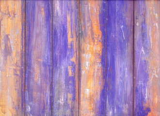 Wooden wall with violet peeling paint