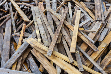 Pile of old used timber planks. Landfill of wooden slats bad