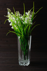Bouquet artificial lily of the valley in a glass