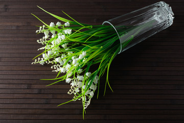 Bouquet artificial lily of the valley in a glass