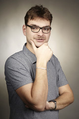 Crazy nerd adult man in glasses make serious  faces in studio