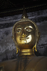 close up face of bronze buddha statue at Bangkok temple in Thailand in Asian culture and religion