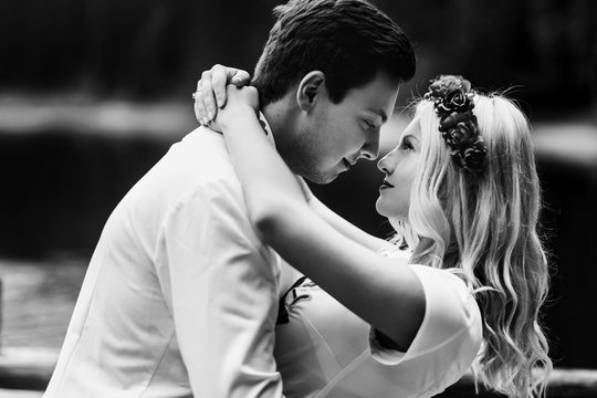 Black and white picture of young wedding couple standing before