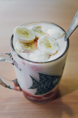cocktail of sour milk with slices of banana and strawberries