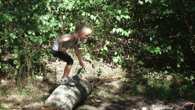 Girl jumping from logs