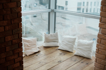 Light glazed balcony with brick wall