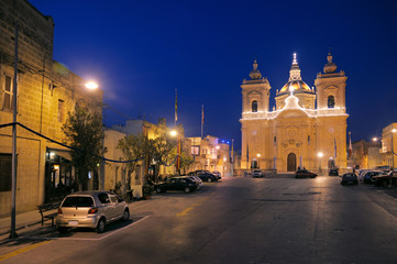 Fototapeta na wymiar Evening view of Xagra town square with Church of Our Lady of Vic