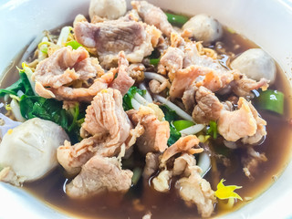 Popular street food in Thailand (Kuai Tiao Moo Namtok) that consisted of pork ball, pork meat, basil or thyme, bean sprouts, morning glory, noodle and creamy soup.