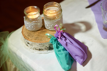 Wedding decoration of the candles on the table in a rustic style