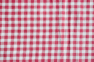 Red picnic tablecloth background, red and white checkered fabric.