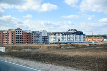 BELARUS, MINSK - APRIL 07/2015: Workers erected a residential complex on the field.