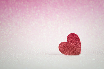 Red heart shapes on pink glitter bokeh light for valentines day background
