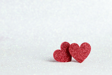 Obraz premium Two red heart shapes on white glitter bokeh light for valentines background