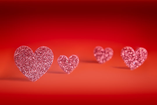 Valentine day background with pink glitter as heart shaped