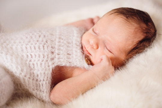 The small baby lies on the bed