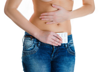 Stomach or menstrual pain. Woman with pains in abdomen. Female belly and hands holding pill package.